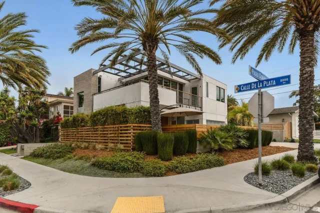 a living room with furniture and a bookshelf