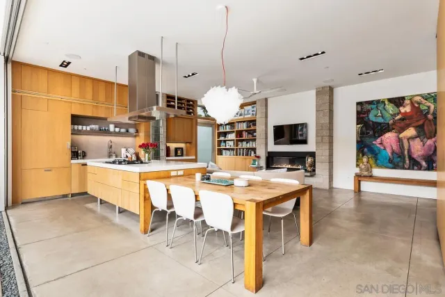 a view of a patio with a table and chairs under an umbrella