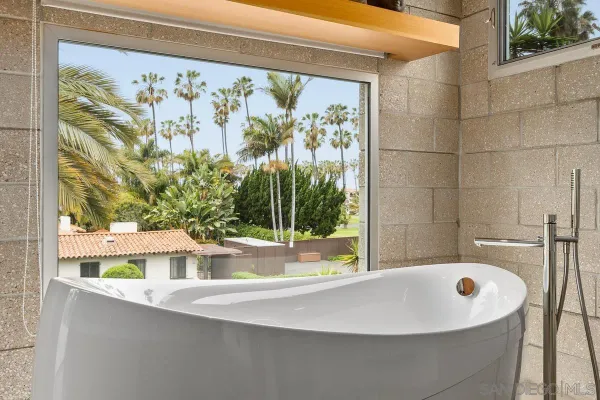a bathroom with a shower sink vanity mirror and toilet