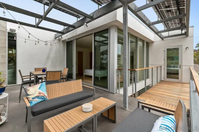 a living room with furniture a lamp and a large window