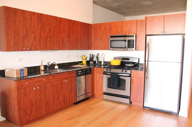 235 West Van Buren Street, Unit 3721 Chicago, IL 60607 - Photo 10 of 17 a kitchen with stainless steel appliances granite countertop a stove a sink and a refrigerator