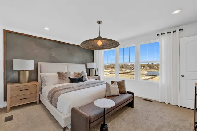 a bed room with a bed and a chair