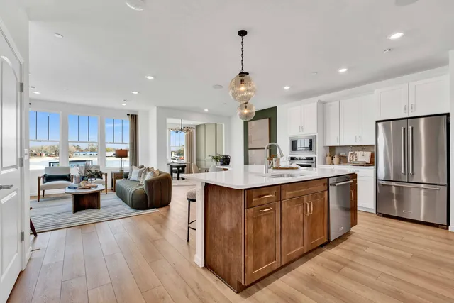 a kitchen with counter top space a sink appliances and cabinets