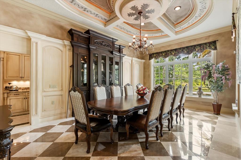 8590 Apache Trail Davenport, FL 33896 - Photo 13 of 100 a view of a dining room with furniture a chandelier and large window