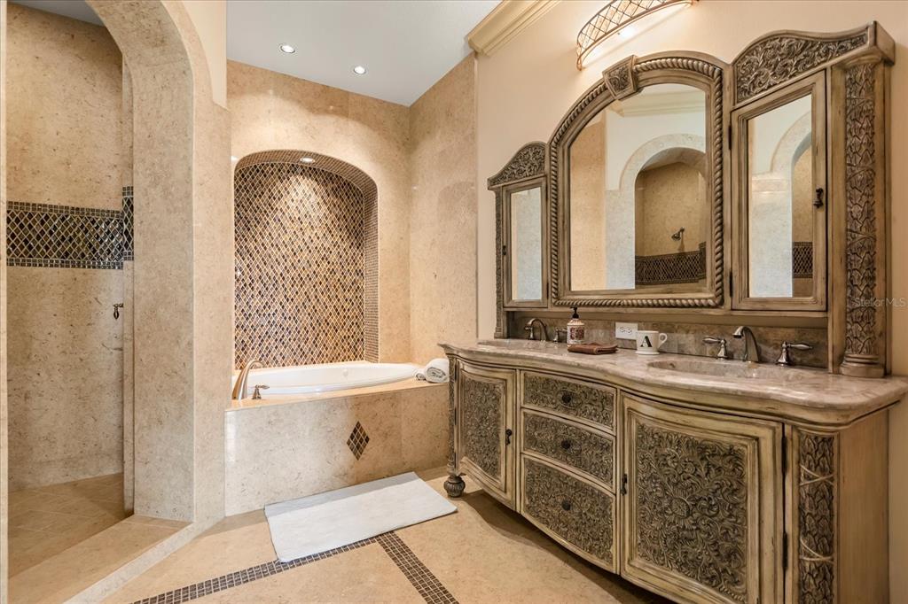 8590 Apache Trail Davenport, FL 33896 - Photo 71 of 100 a spacious bathroom with a double vanity sink a mirror and a shower