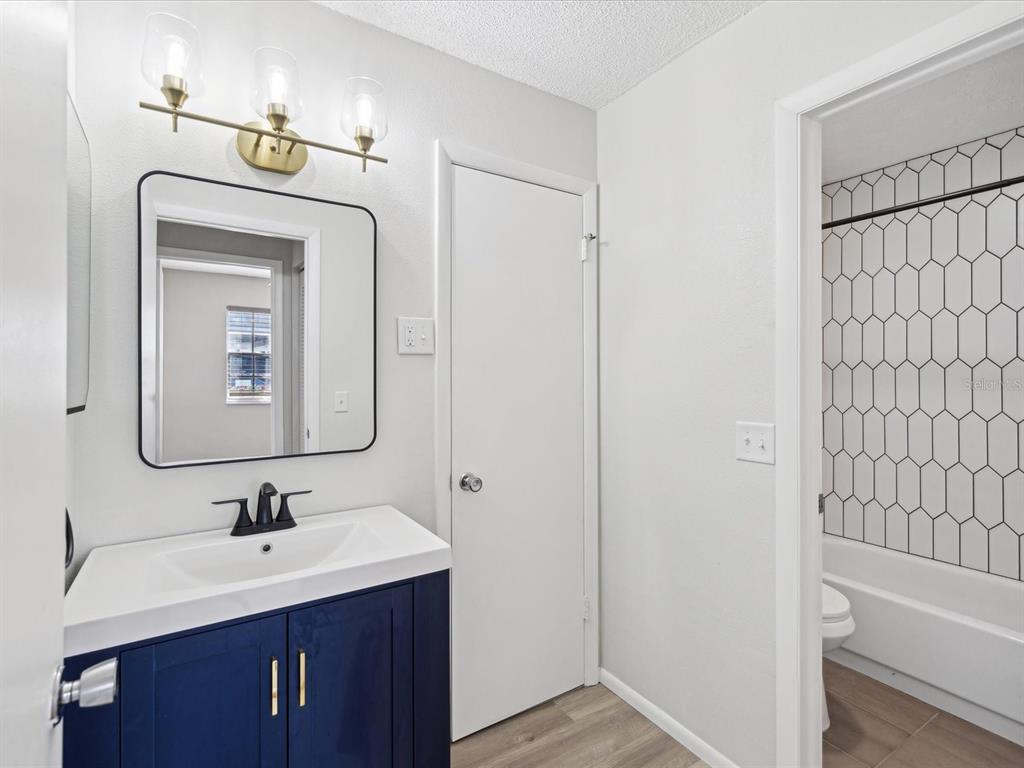 3717 Trophy Boulevard New Port Richey, FL 34655 - Photo 11 of 35 a bathroom with a sink a toilet and shower