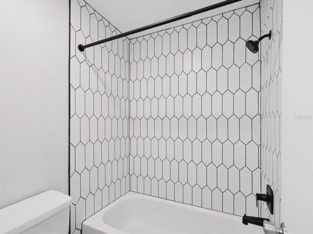 a bathroom with a white bath tub and a shower curtain