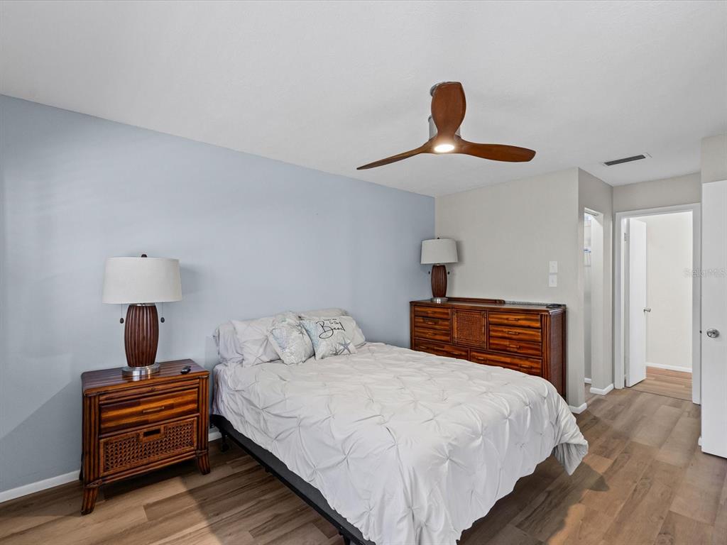 3717 Trophy Boulevard New Port Richey, FL 34655 - Photo 14 of 35 a bedroom with a bed and a chandelier