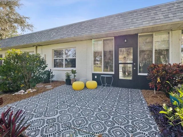 a view of a house with a backyard and sitting area