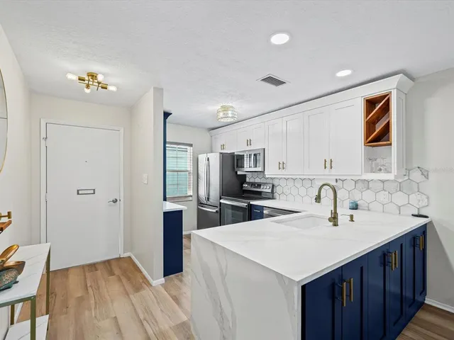a kitchen with a sink and refrigerator