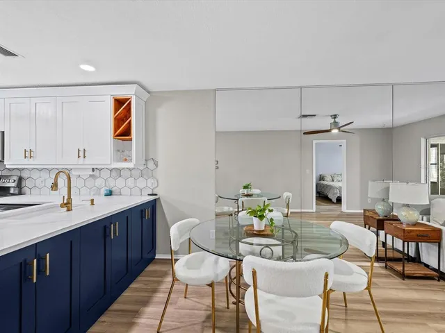 a living room with furniture a dining table and kitchen view