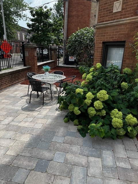 1614 North Harding Avenue, Unit 3E Chicago, IL 60647 - Photo 3 of 14 a backyard of a house with lots of green space and outdoor seating