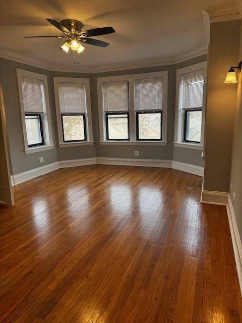 1614 North Harding Avenue, Unit 3E Chicago, IL 60647 - Photo 6 of 14 a view of an empty room with wooden floor and a window