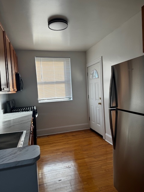 1614 North Harding Avenue, Unit 3E Chicago, IL 60647 - Photo 10 of 14 a view of kitchen with a refrigerator dryer and a window