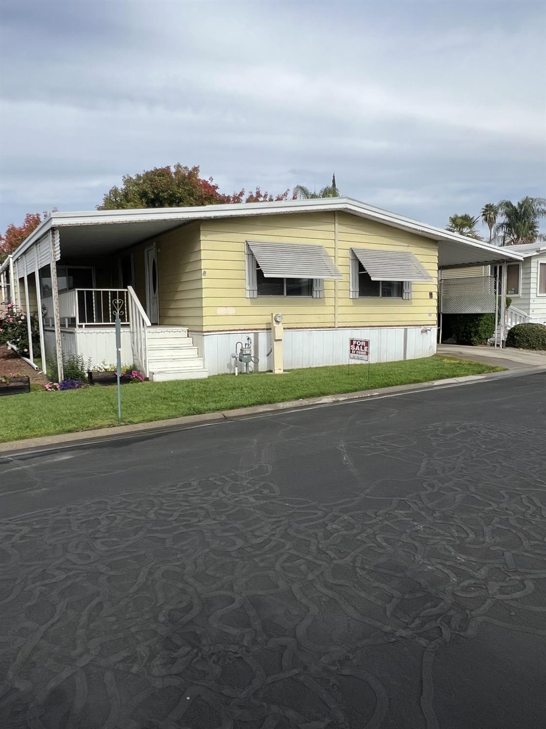 1218 East Cleveland Avenue, Unit 2 Madera, CA 93638 - Photo 1 of 8 a front view of a house with a garden and parking