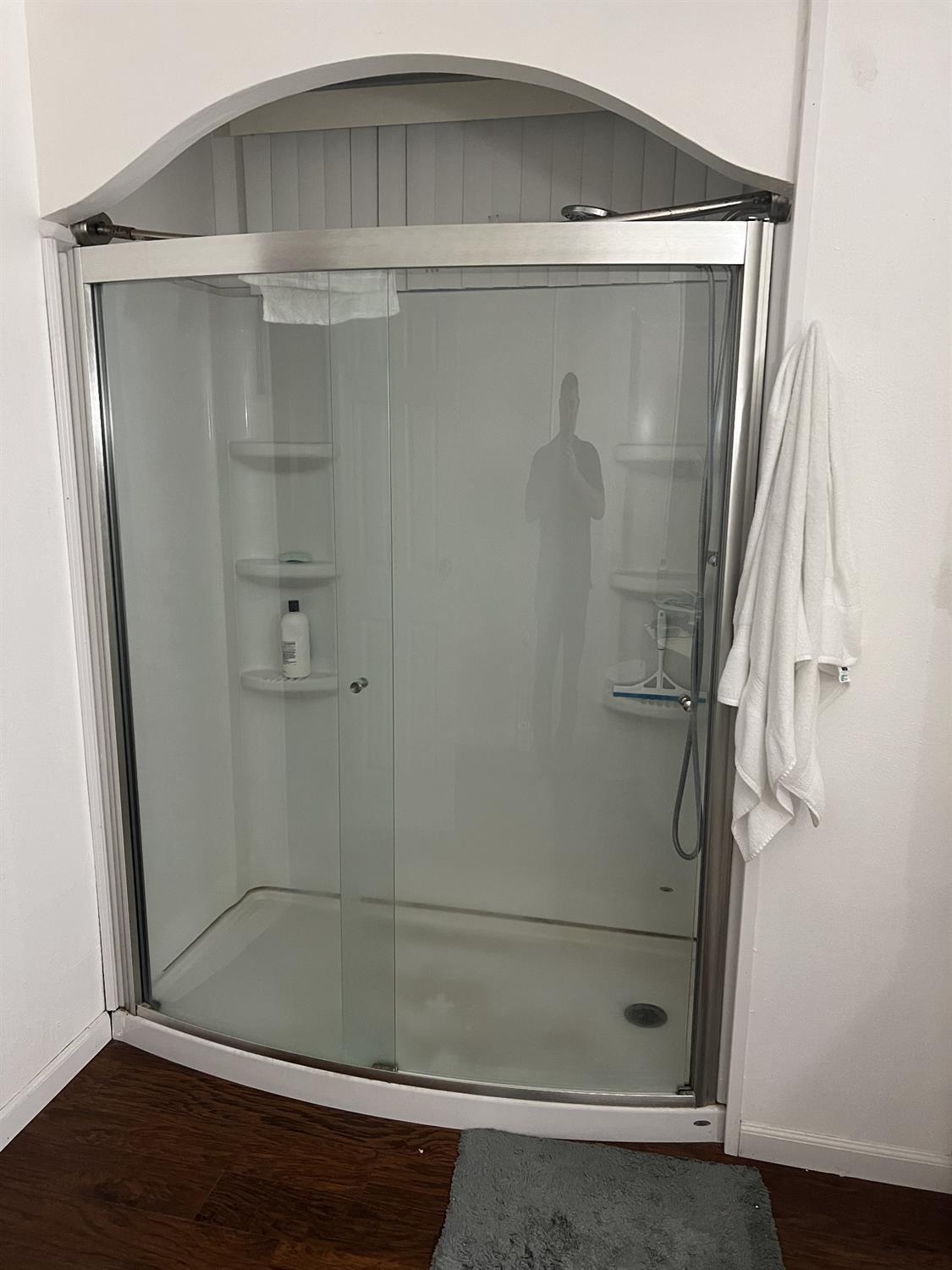 1218 East Cleveland Avenue, Unit 2 Madera, CA 93638 - Photo 3 of 8 a bathroom with a glass shower door