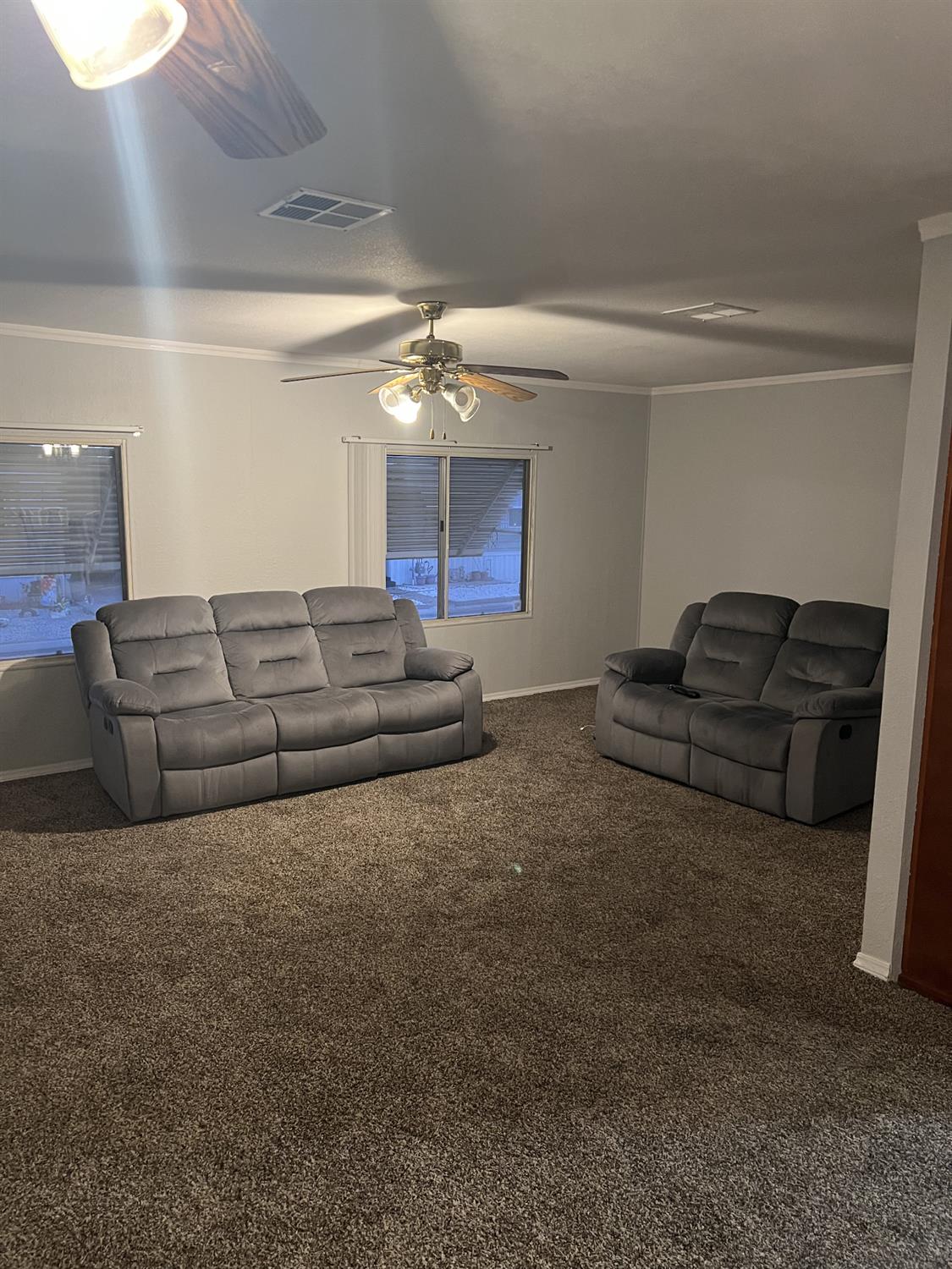 1218 East Cleveland Avenue, Unit 2 Madera, CA 93638 - Photo 5 of 8 a living room with couches and flowerpot