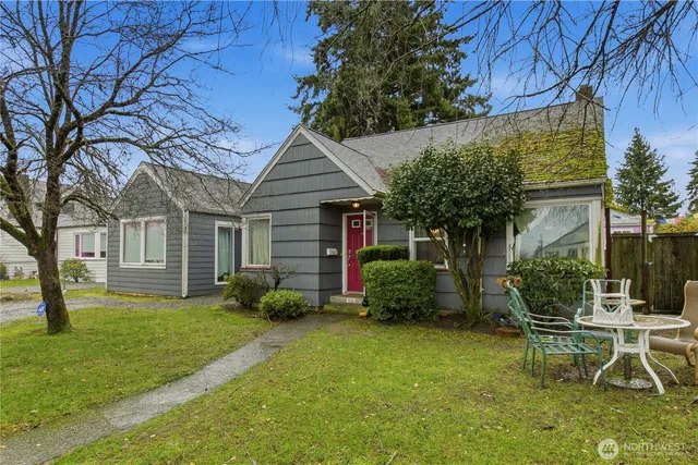a backyard of a house with table and chairs