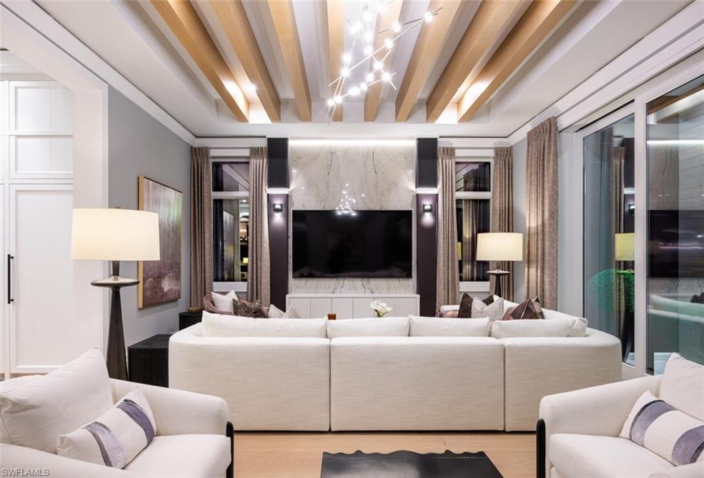 405 Neapolitan Way Naples, FL 34103 - Photo 13 of 50 a living room with furniture and a flat screen tv