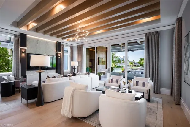 a living room with furniture a fireplace and a large window