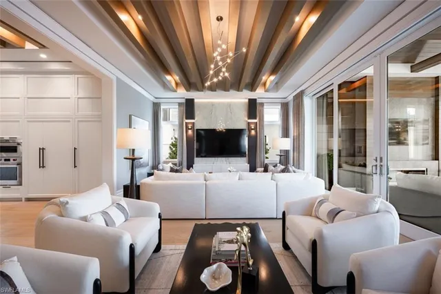 a kitchen with white cabinets and black appliances