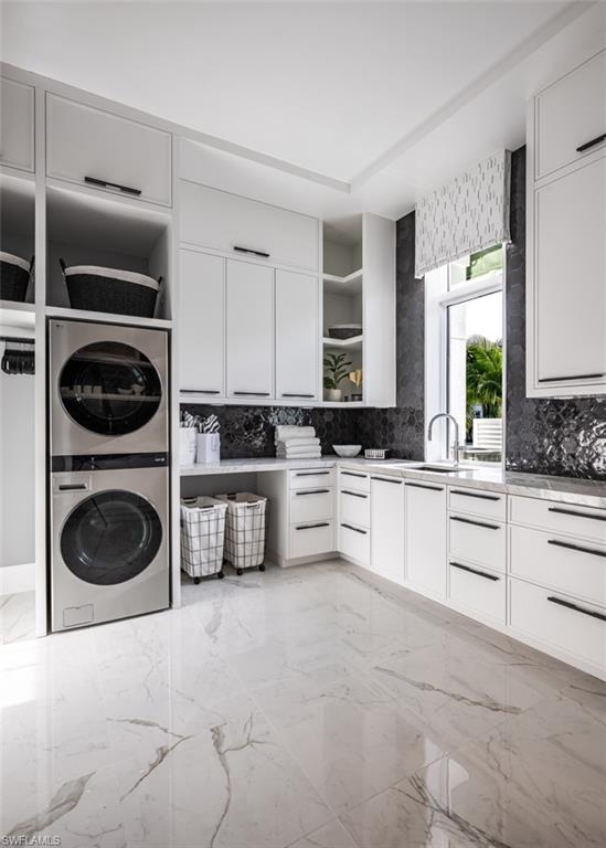 405 Neapolitan Way Naples, FL 34103 - Photo 17 of 50 a kitchen with cabinets a washer and dryer