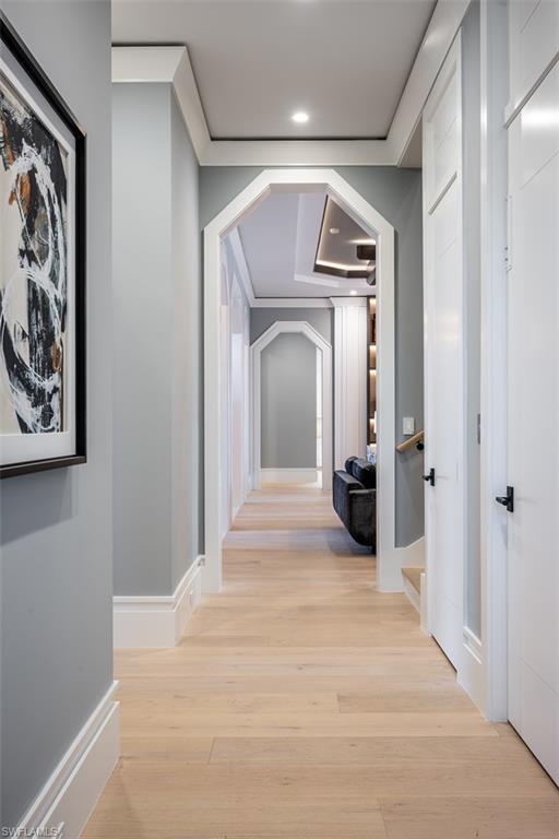 405 Neapolitan Way Naples, FL 34103 - Photo 18 of 50 a view of a hallway with wooden floor and a bathroom