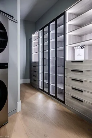 a spacious bedroom with a bed and a chandelier