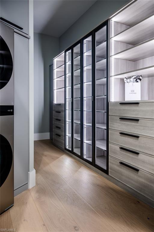 405 Neapolitan Way Naples, FL 34103 - Photo 22 of 50 a view of walk in closet with clothes and shoes