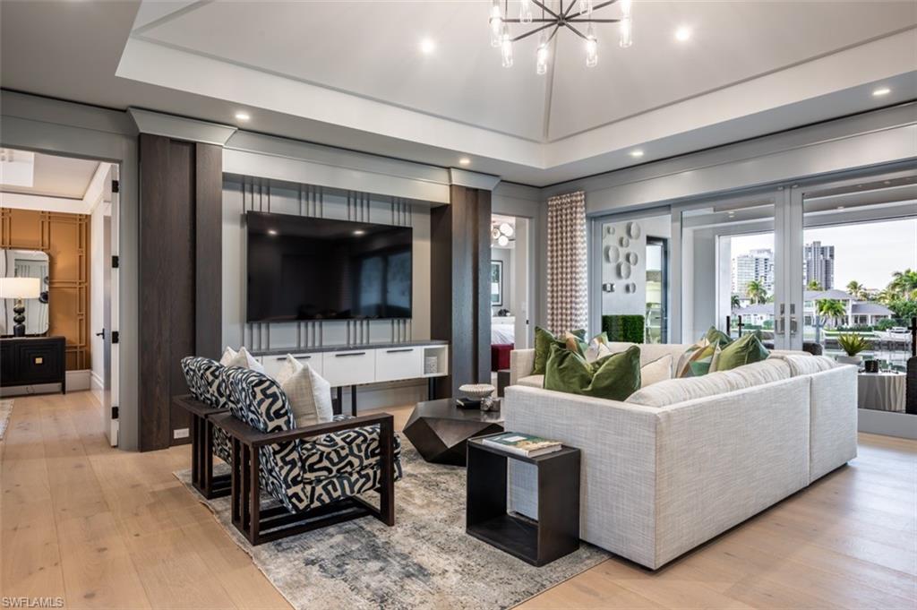 405 Neapolitan Way Naples, FL 34103 - Photo 26 of 50 a living room with furniture and a flat screen tv