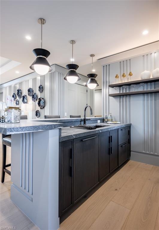 405 Neapolitan Way Naples, FL 34103 - Photo 30 of 50 a kitchen with granite countertop a sink and cabinets