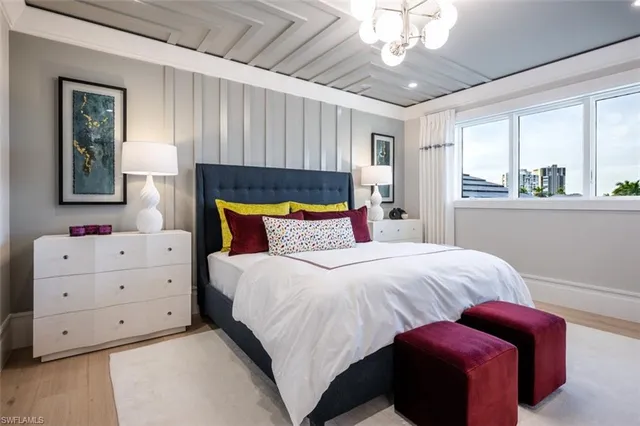 a bedroom with a large bed and a window