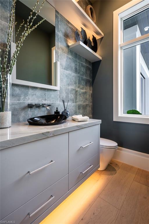 405 Neapolitan Way Naples, FL 34103 - Photo 39 of 50 a bathroom with a sink and a mirror