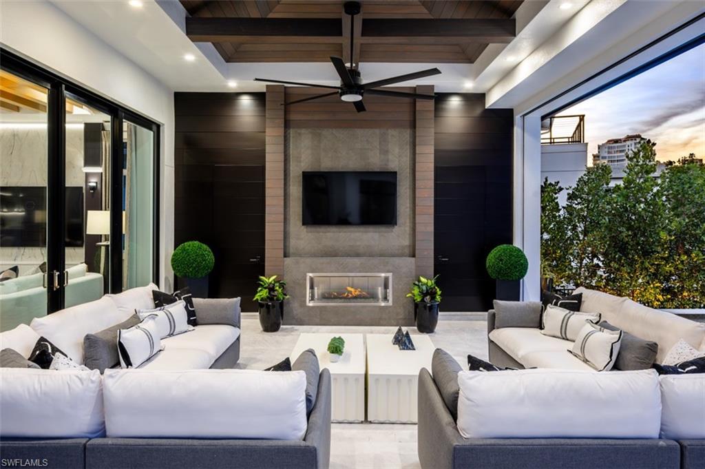 405 Neapolitan Way Naples, FL 34103 - Photo 43 of 50 a living room with furniture and a flat screen tv