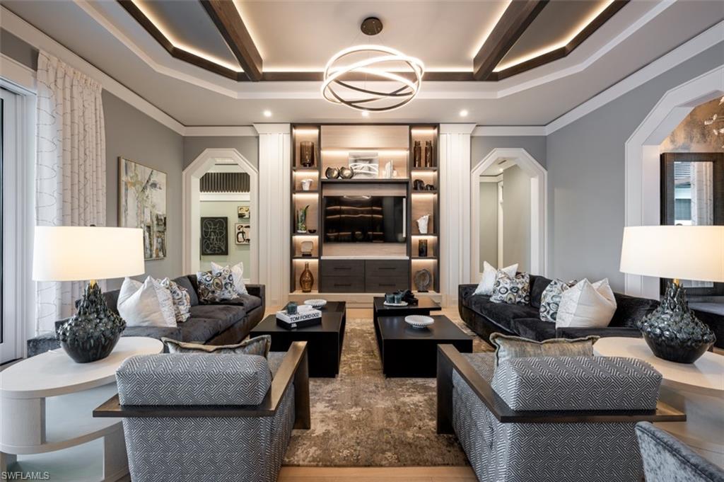 405 Neapolitan Way Naples, FL 34103 - Photo 5 of 50 a living room with fireplace furniture and a chandelier