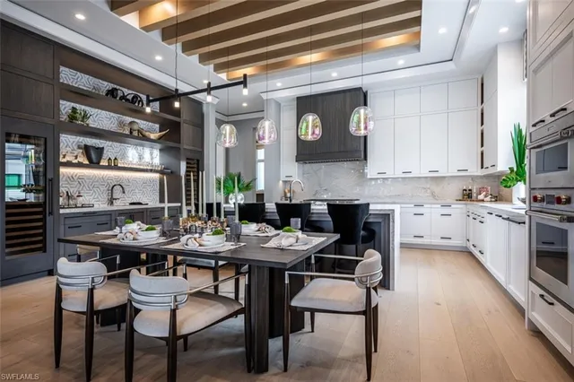a kitchen with a table chairs stove and cabinets