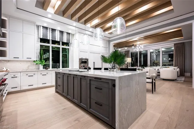 a kitchen with counter top space and windows