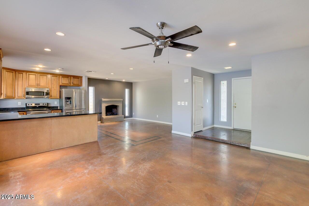 3832 East Bloomfield Road Phoenix, AZ 85032 - Photo 5 of 32 a view of a kitchen with a sink and a refrigerator