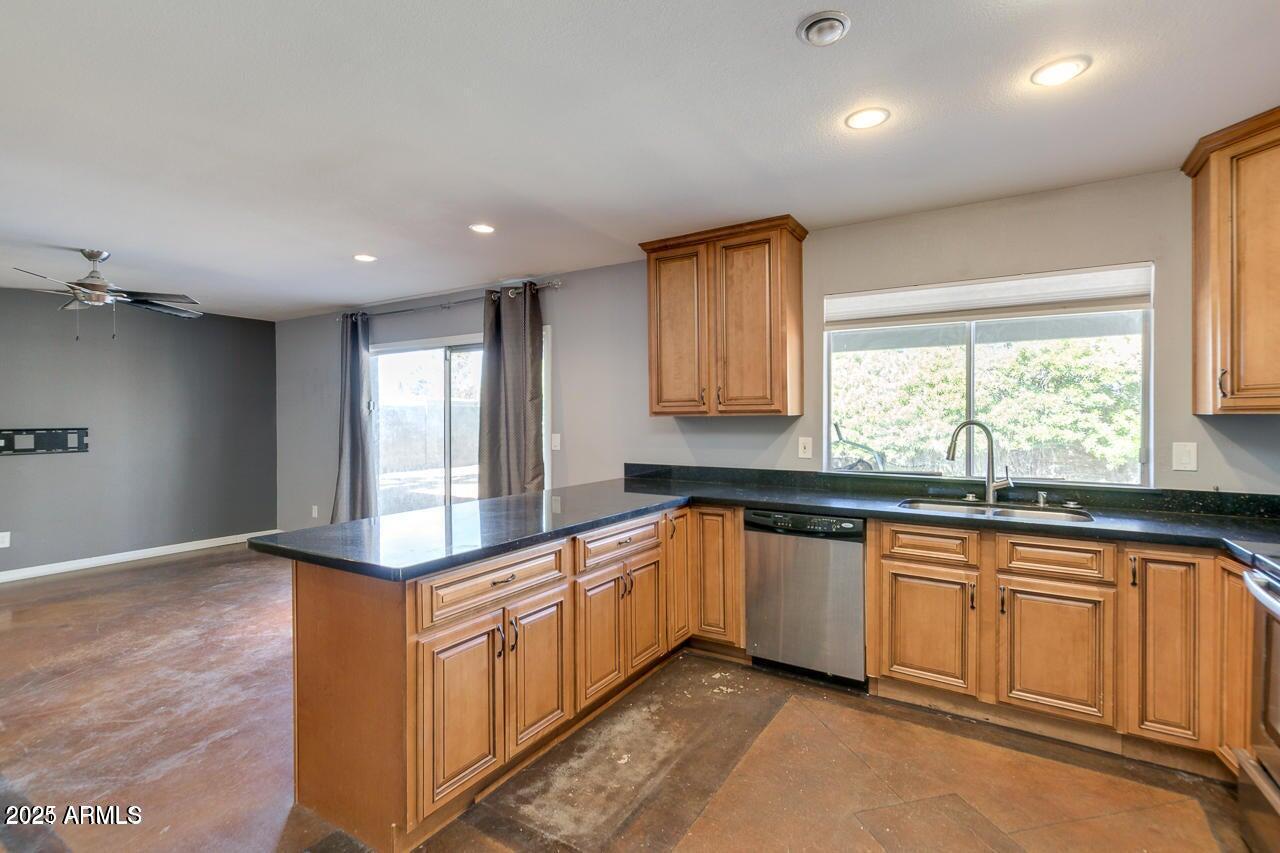 3832 East Bloomfield Road Phoenix, AZ 85032 - Photo 10 of 32 a large kitchen with granite countertop a sink and dishwasher a stove with wooden floors