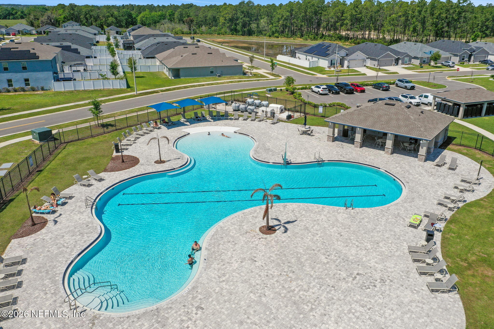 1214 Fury Street Davenport, FL 33837 - Photo 30 of 37 a view of a swimming pool with a garden and seating area