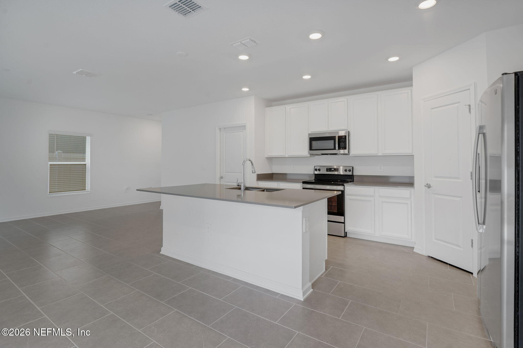 1214 Fury Street Davenport, FL 33837 - Photo 7 of 37 a kitchen with stainless steel appliances granite countertop a refrigerator sink and stove