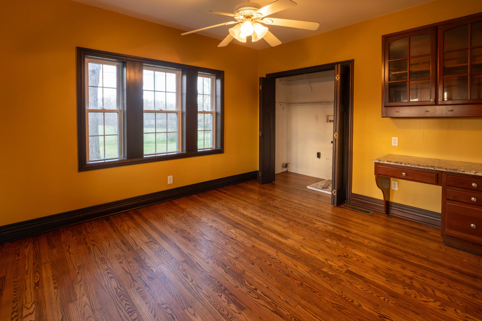 510 Rosebower Church Road Paducah, KY 42003 - Photo 21 of 52 a view of an empty room with wooden floor and a window