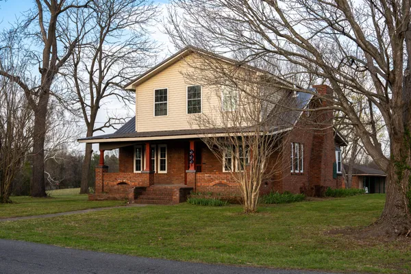 a front view of a house with a garden