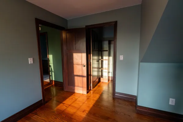 a view of a livingroom with wooden floor and a window