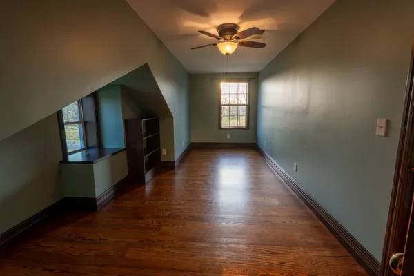 a view of a livingroom with wooden floor and a window