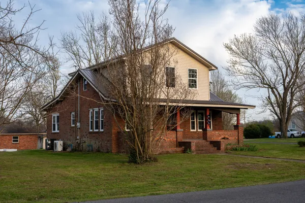 a front view of a house with a garden