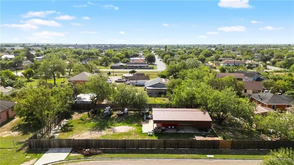 an aerial view of residential houses with yard and swimming pool