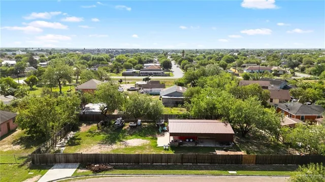 an aerial view of residential houses with yard and swimming pool