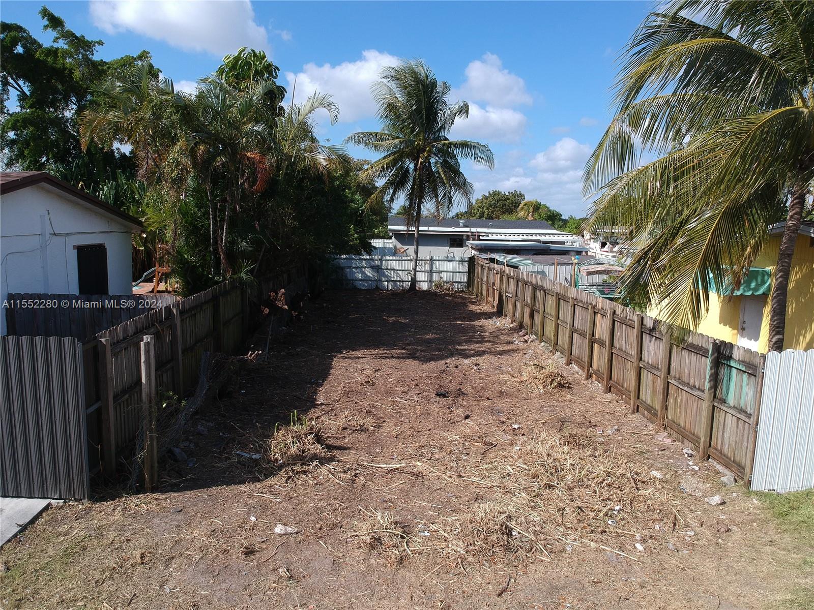 184 Eureka Miami, FL 33177 - Photo 2 of 13 a view of a house with a yard covered with wooden fence