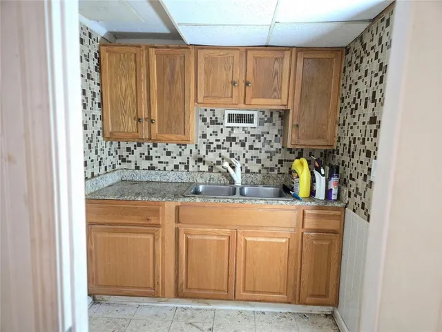 a kitchen with stainless steel appliances granite countertop a sink and a cabinets